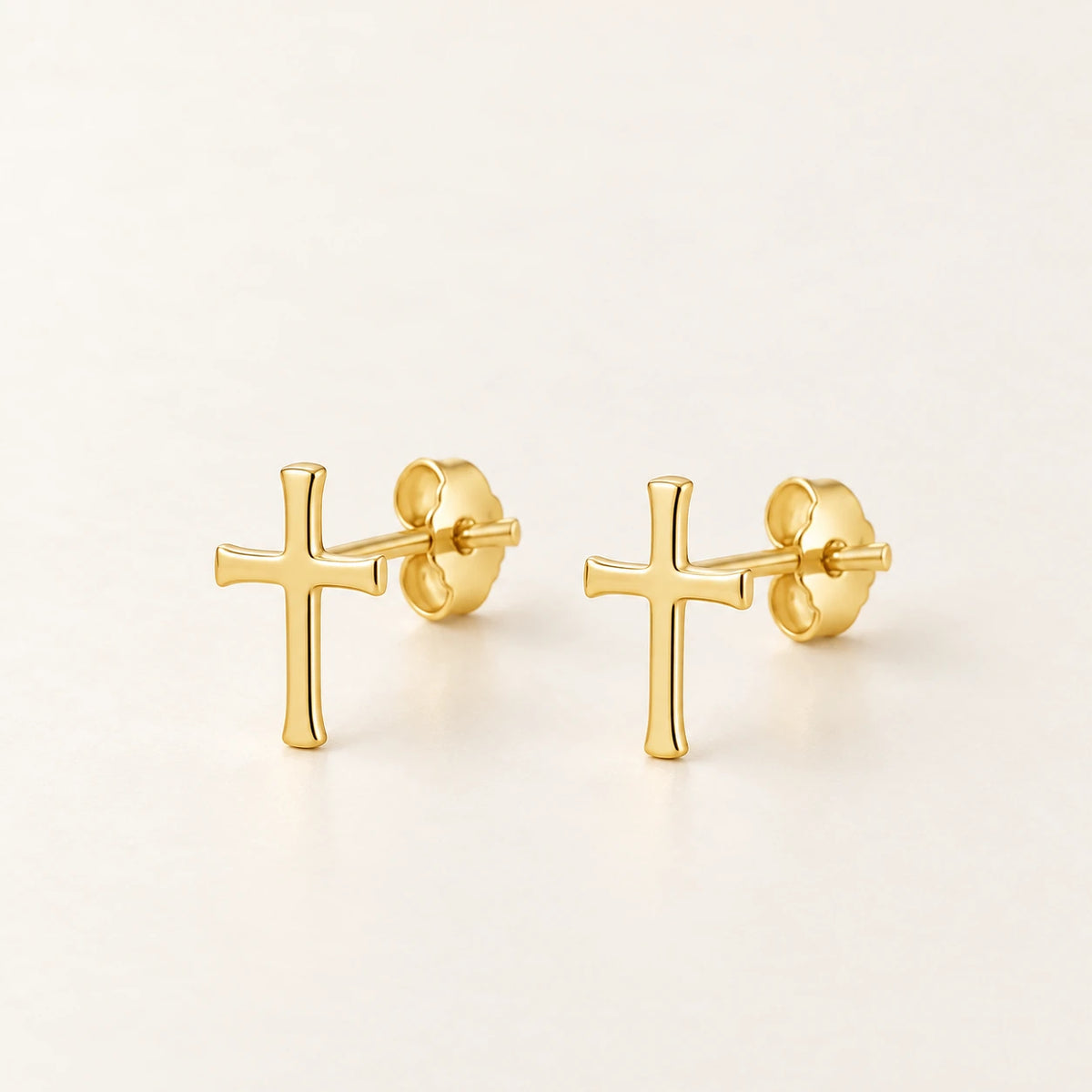 The Cross Studs, gold-plated stainless steel, shown on its own