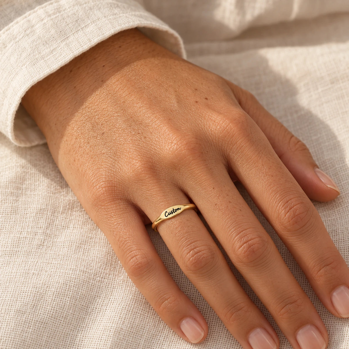 The Initial Ring worn, gold-plated stainless steel