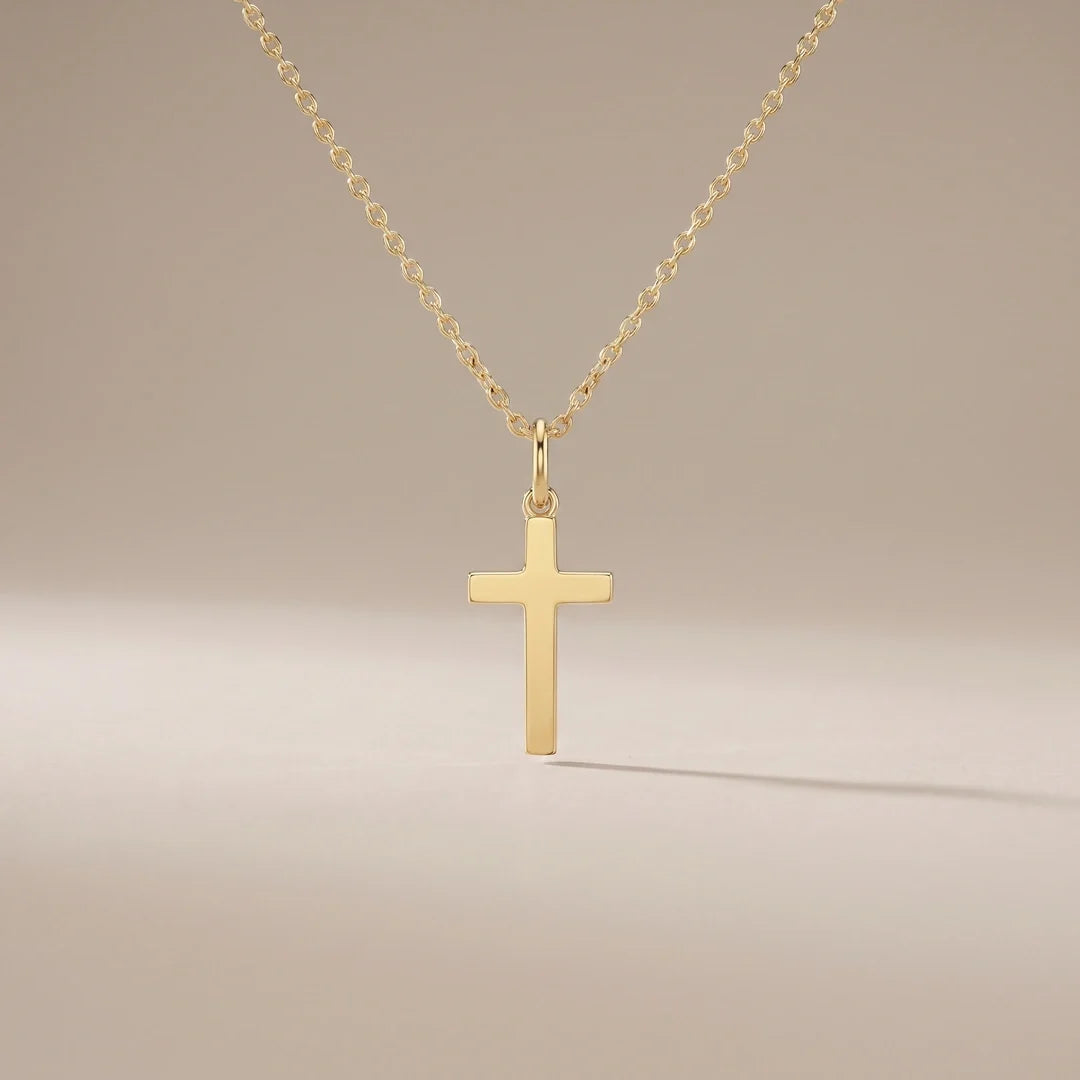 Guardian Cross, a sealed 18K gold cross pendant necklace, on a plain background