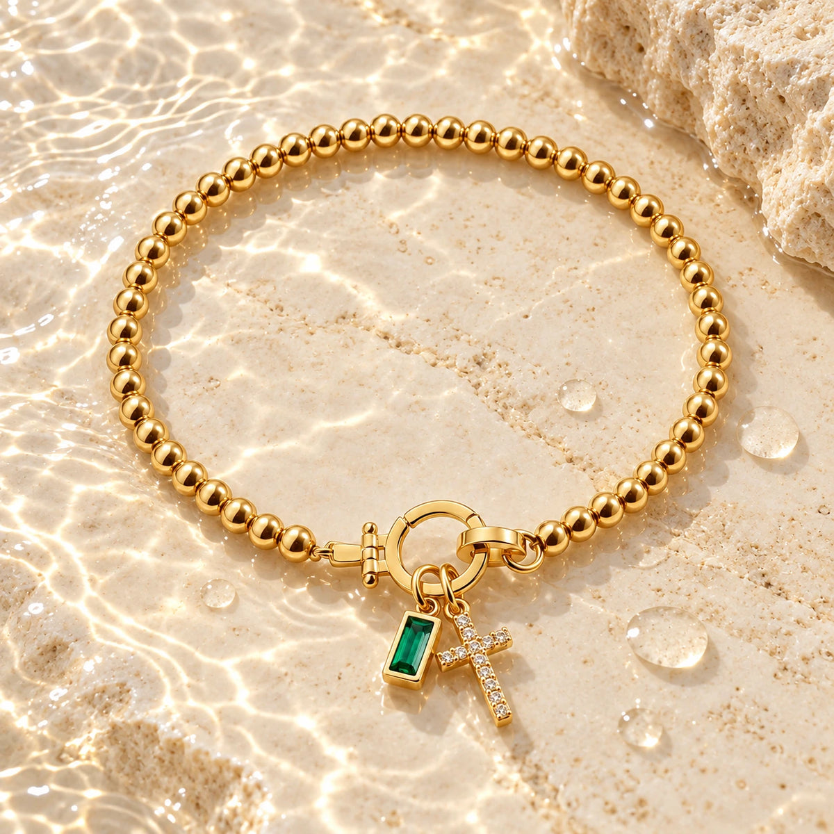 Birth Month Crystal Cross Charm Bracelet with water droplets on stone