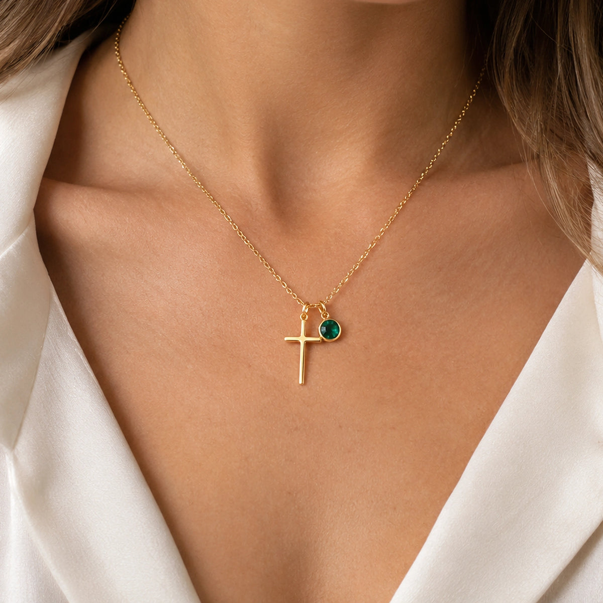 Birthstone Cross Necklace worn at the neckline, framed below the chin.