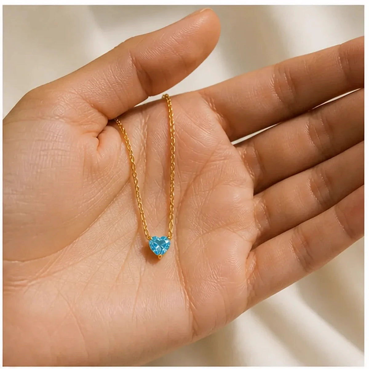Amada | Birthstone Heart Necklace | scale in hand | cycle 3