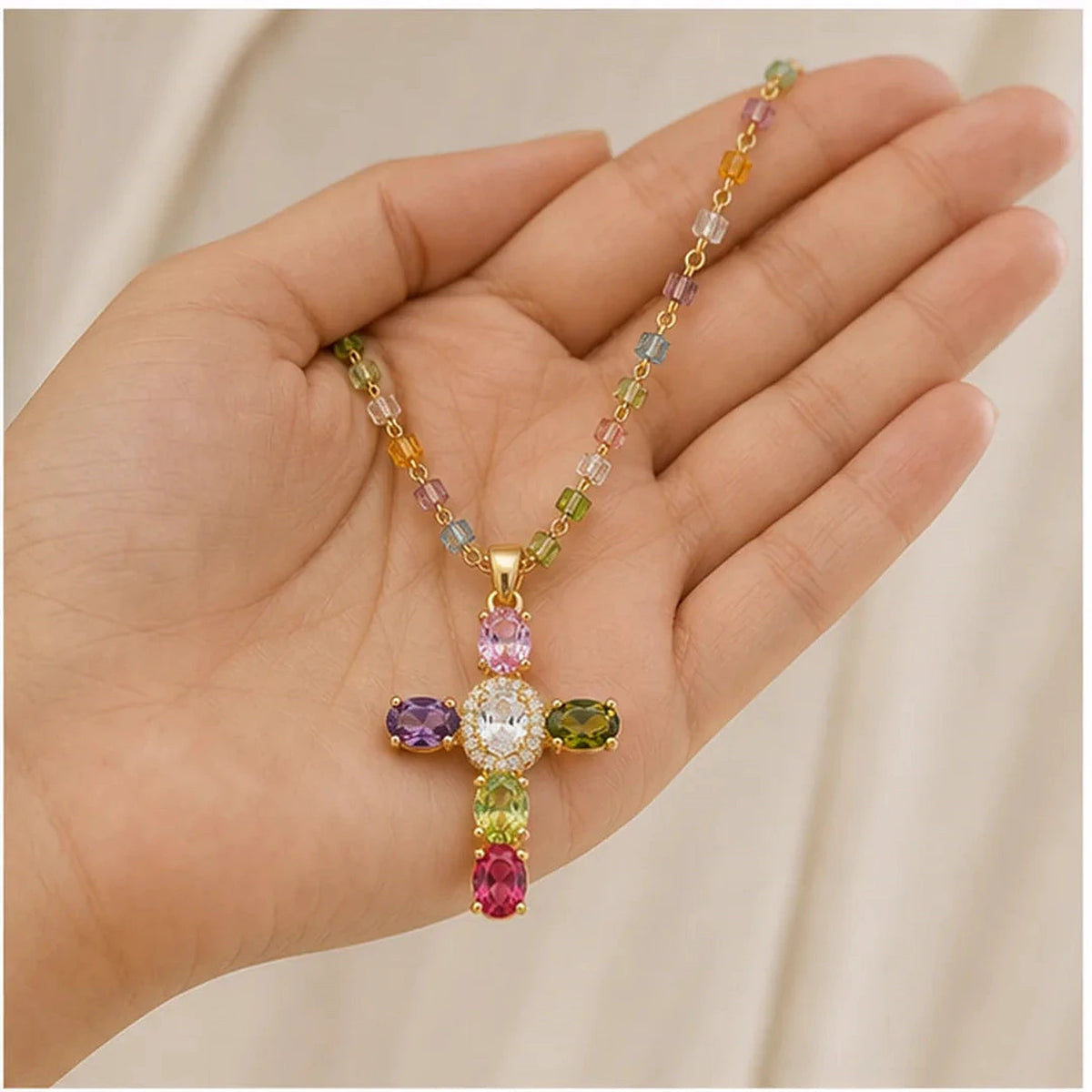 Amada | Colorful Crystal Cross Necklace | scale in hand | cycle 3