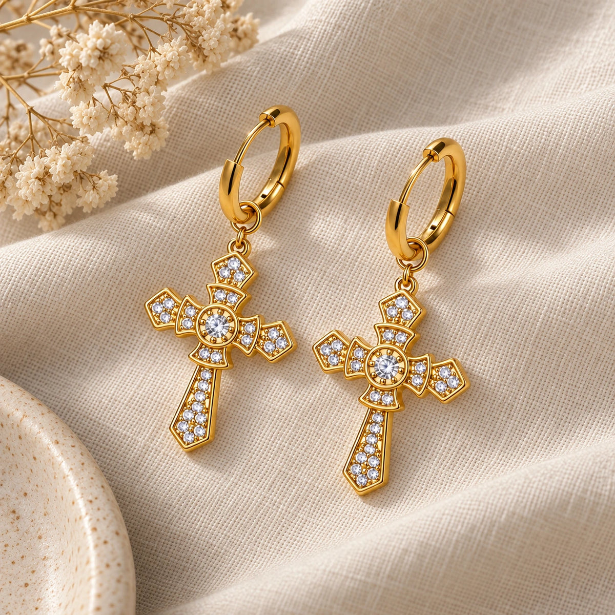 Cross Hoop Earrings laid flat on linen