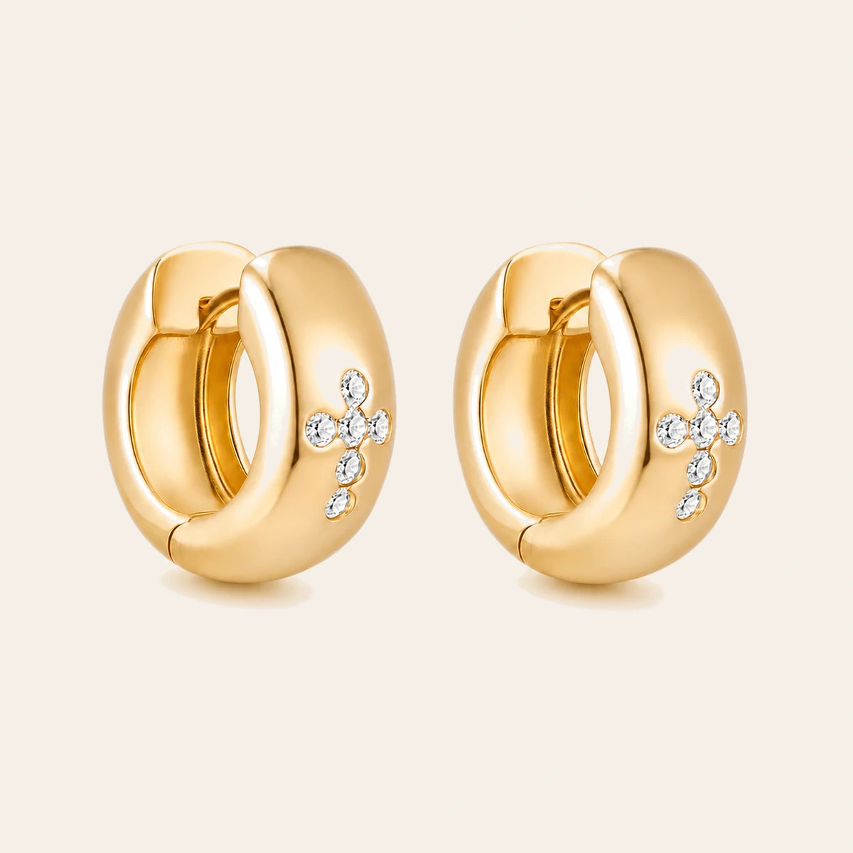 Amada Cross Huggie Earrings on ivory background
