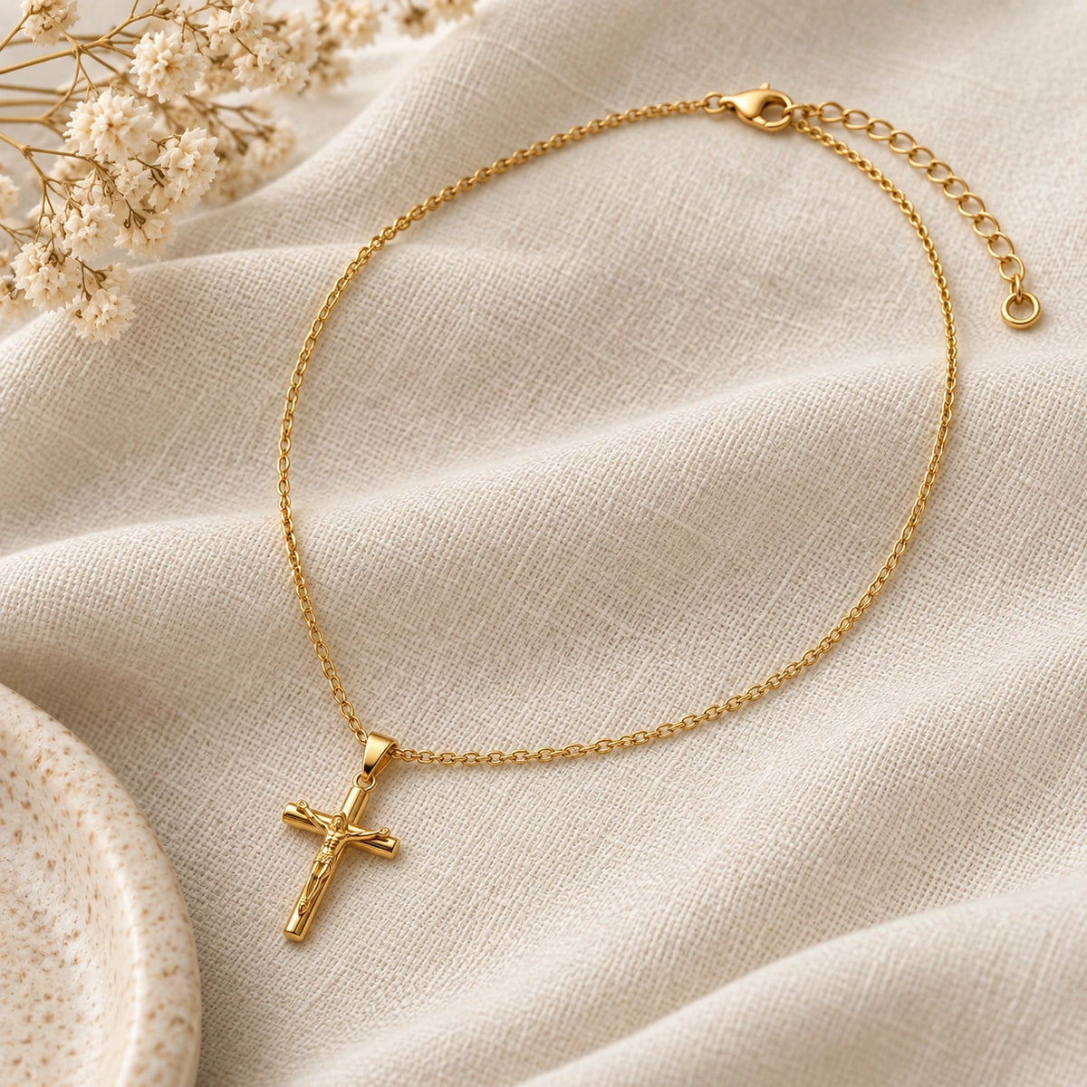 Crucifix Necklace laid flat on linen