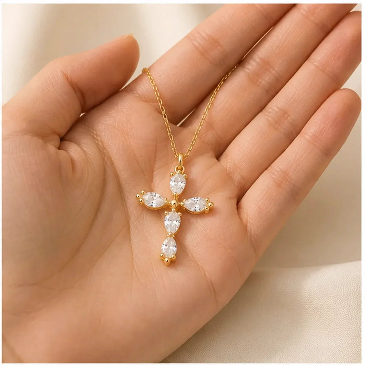 Amada | Dainty Crystal Cross Necklace | scale in hand | cycle 3
