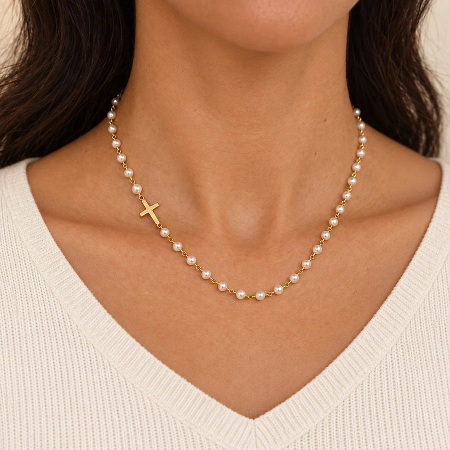 Hands handing over an Amada gift box with a gold-plated cross necklace inside