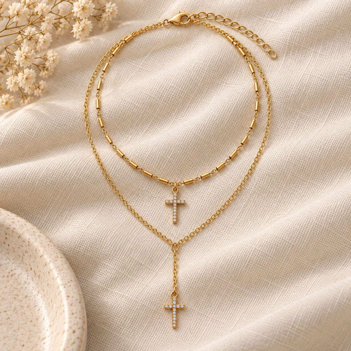 Double Layer Cross Necklace laid flat on linen