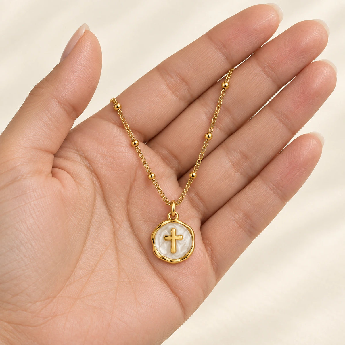 Enamel Cross Pendant held in hand, showing its true scale