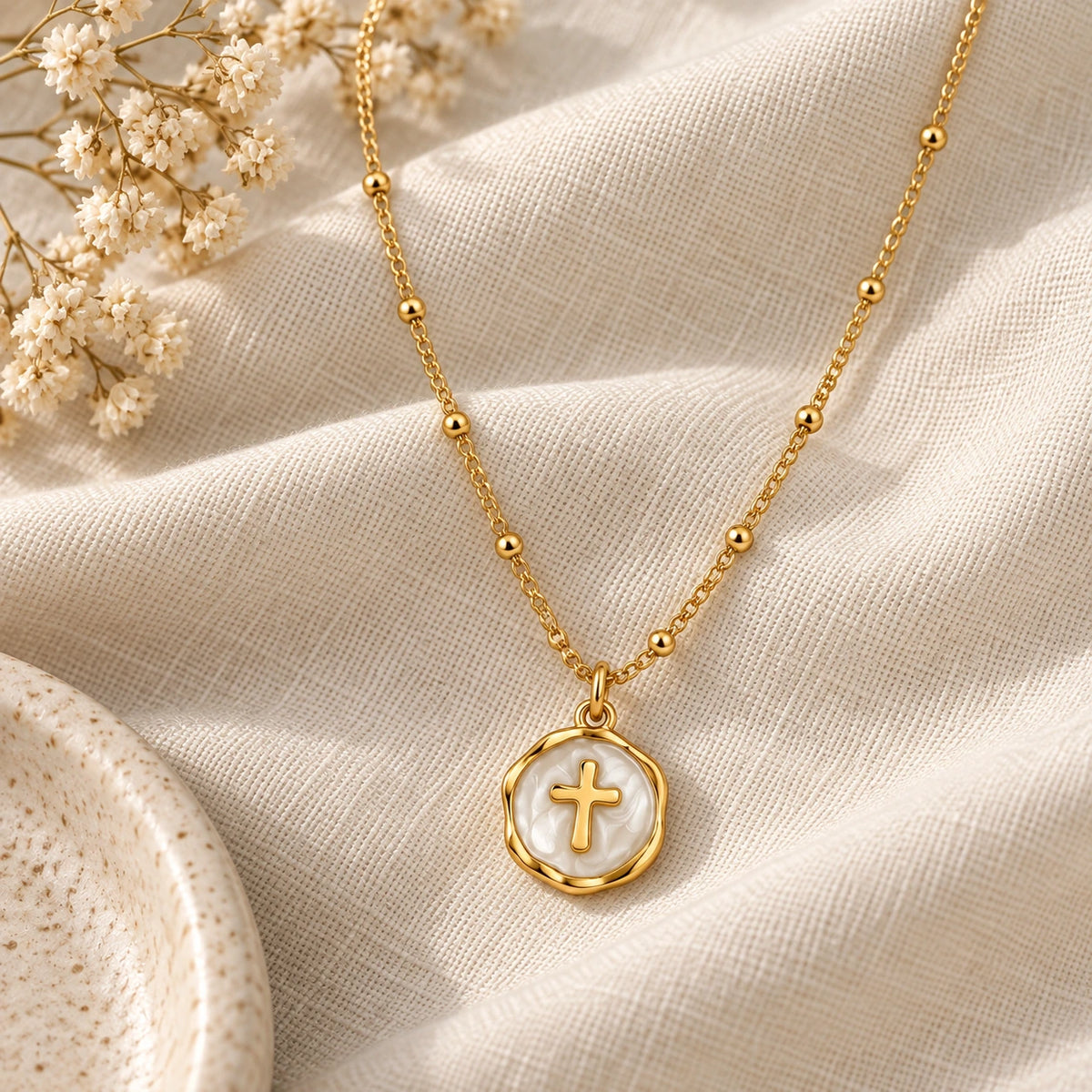 Enamel Cross Pendant laid flat on linen