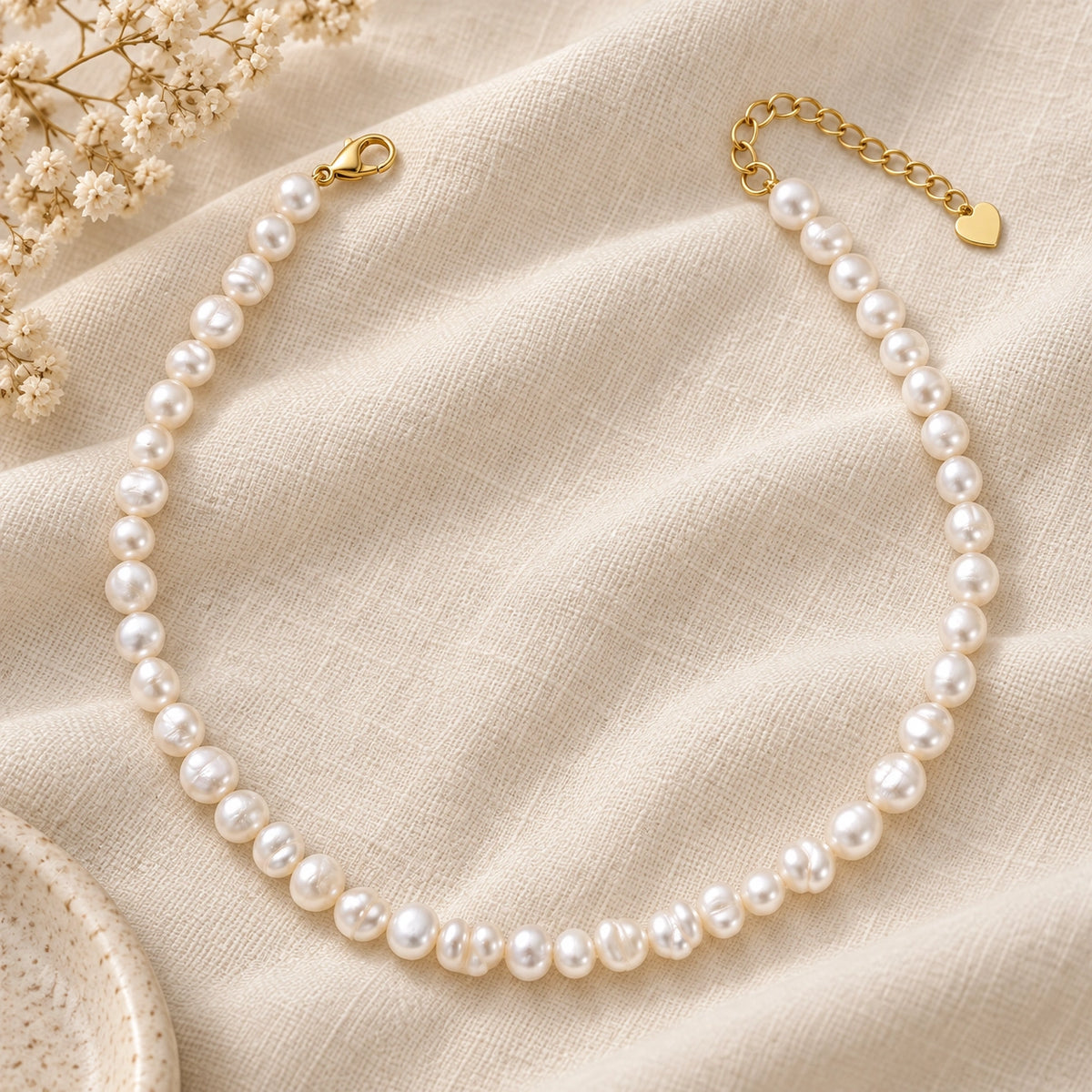 Amada Faux Pearl Strand Necklace laid flat on fabric.