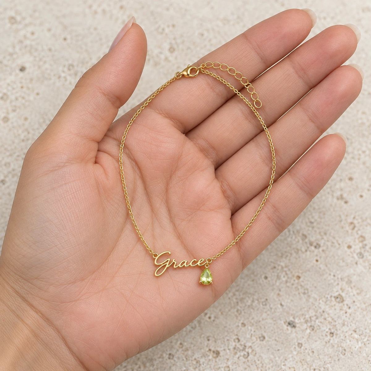 Name Necklace with Birth Month Crystal held in hand, showing its true scale