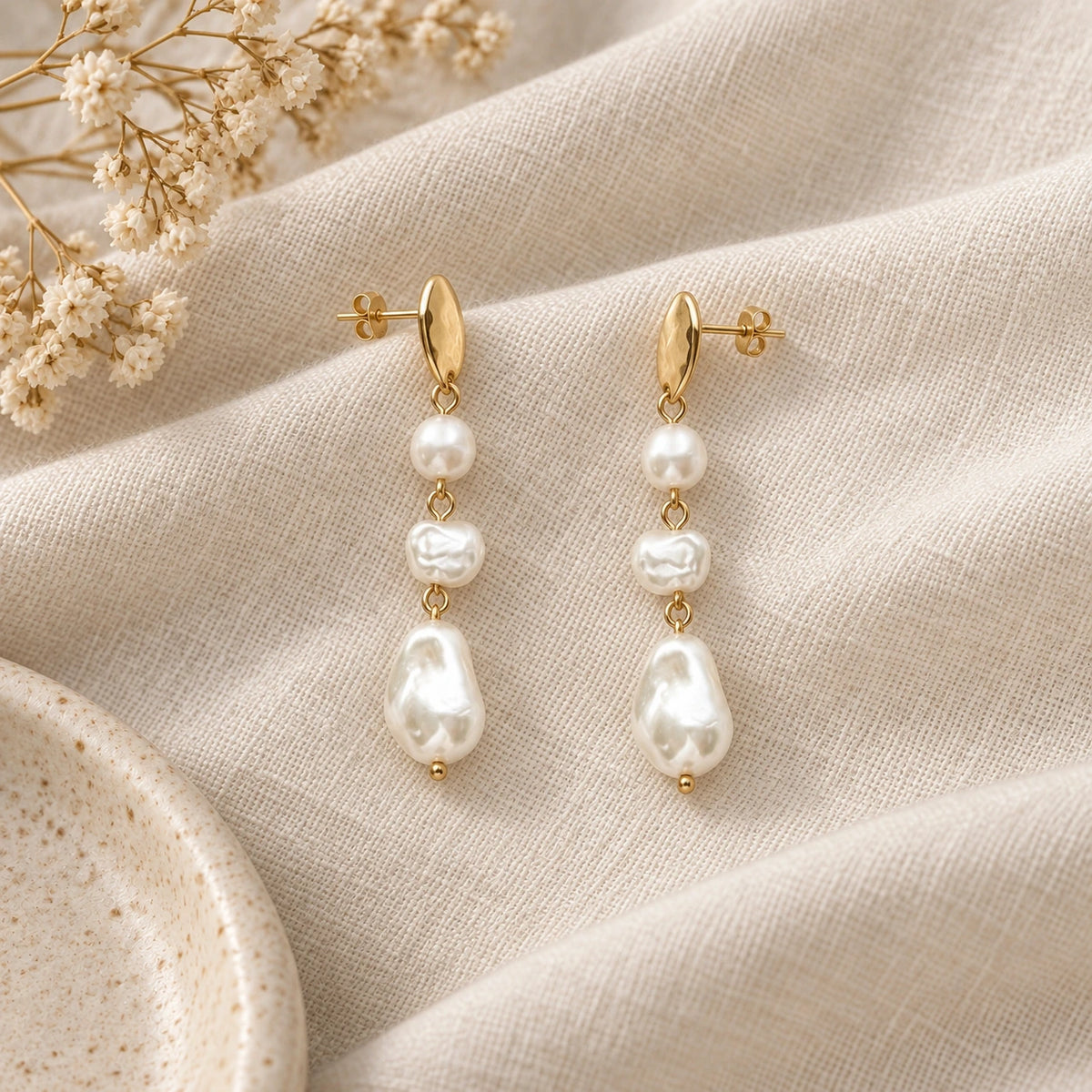Grace Faux Pearl Drop Earrings laid flat on linen