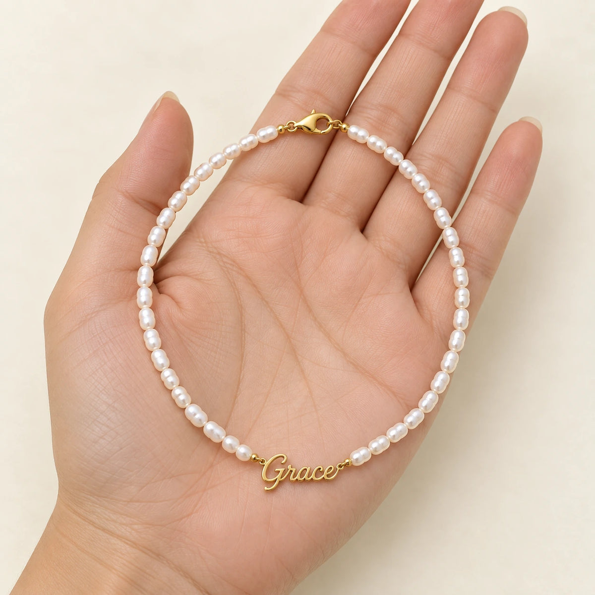Pearl Name Necklace held in hand, showing its true scale