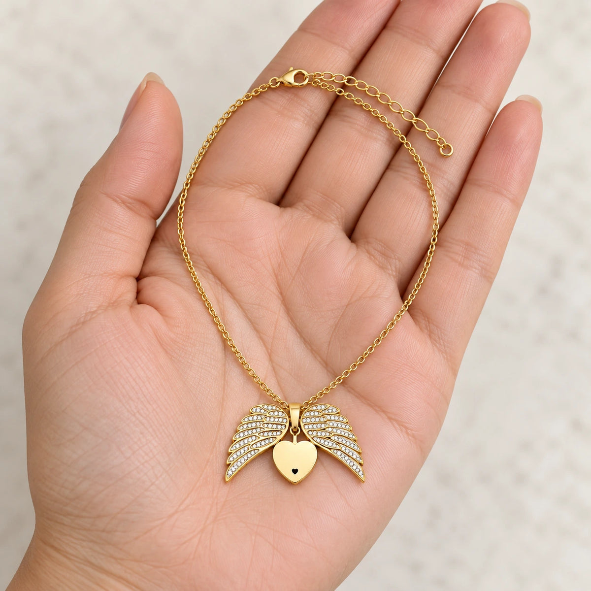 Guardian Angel Necklace held in hand, showing its true scale