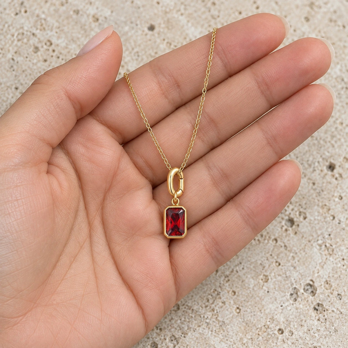 Her Birth Month Charm held in hand, showing its true scale