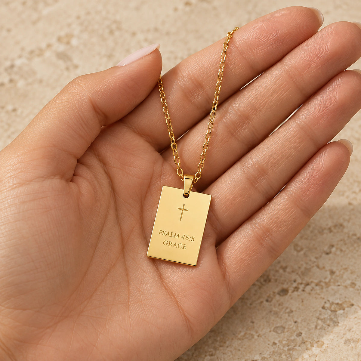 His Promise Necklace resting in an open palm to show the pendant size.