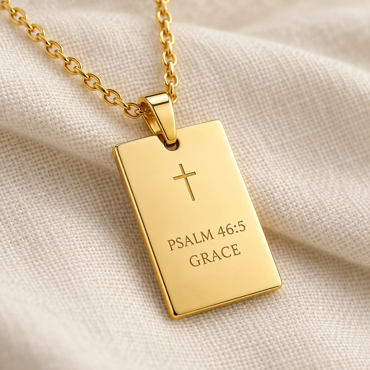 Engraved His Promise pendant resting on ivory linen.