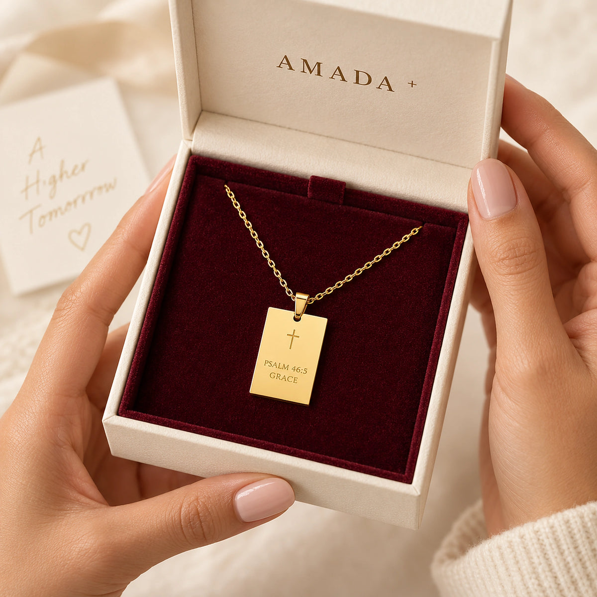 Hands holding an open Amada gift box with the His Promise Necklace inside.