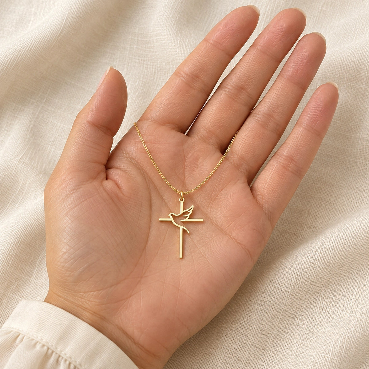 Amada Holy Spirit Dove Necklace held in a hand for a sense of its real size.