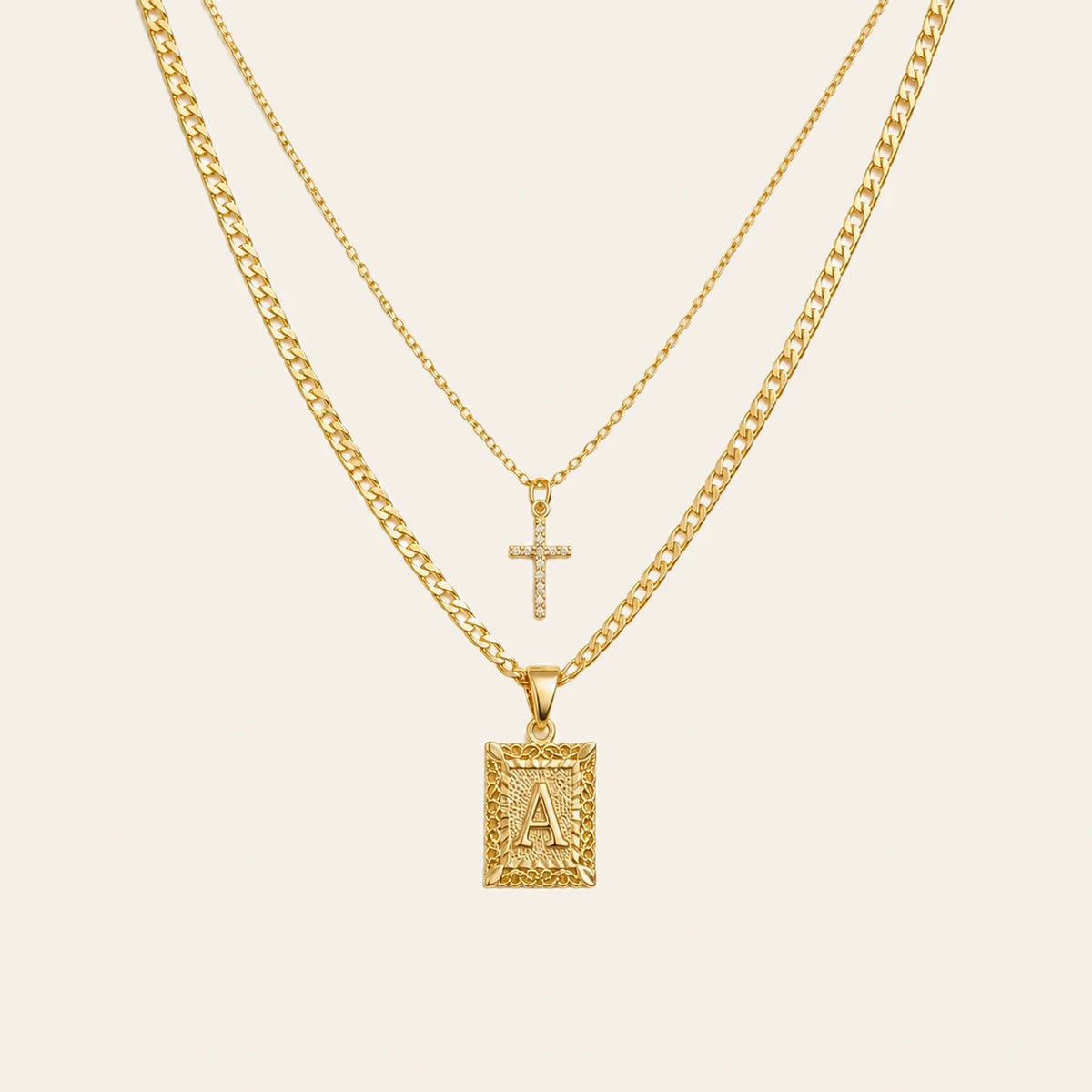 Amada Initial & Cross Necklace Set on ivory background