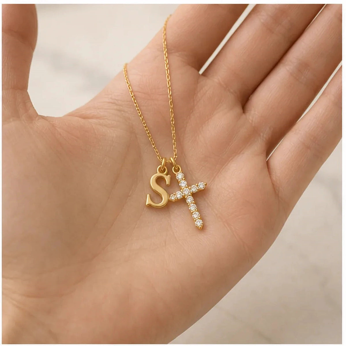Amada | Initial Crystal Cross Necklace | scale in hand | cycle 3
