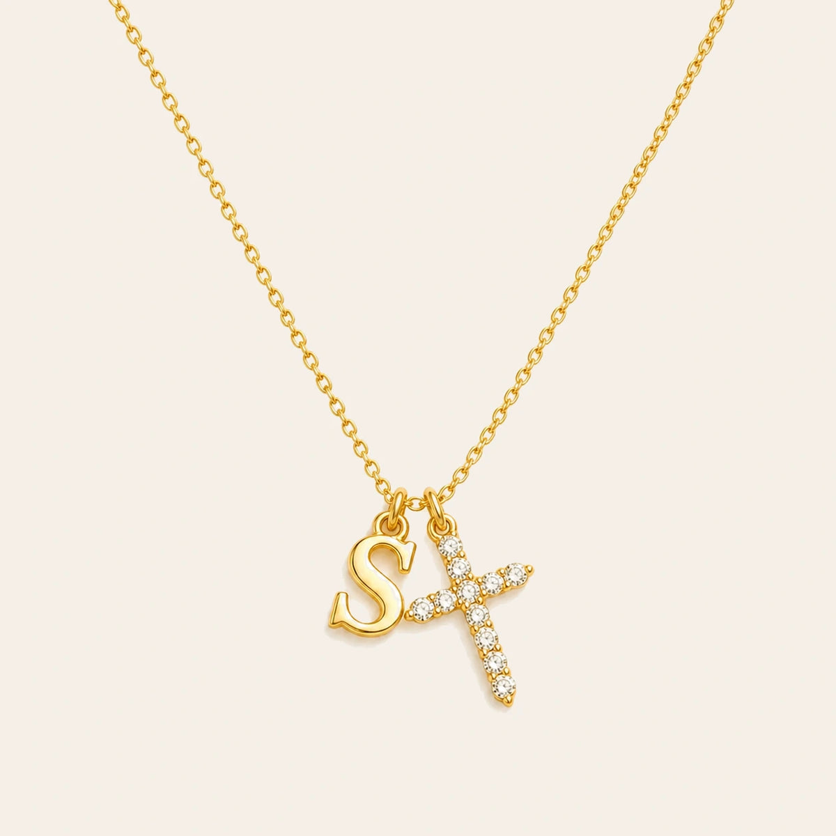 Amada Initial Crystal Cross Necklace on ivory background
