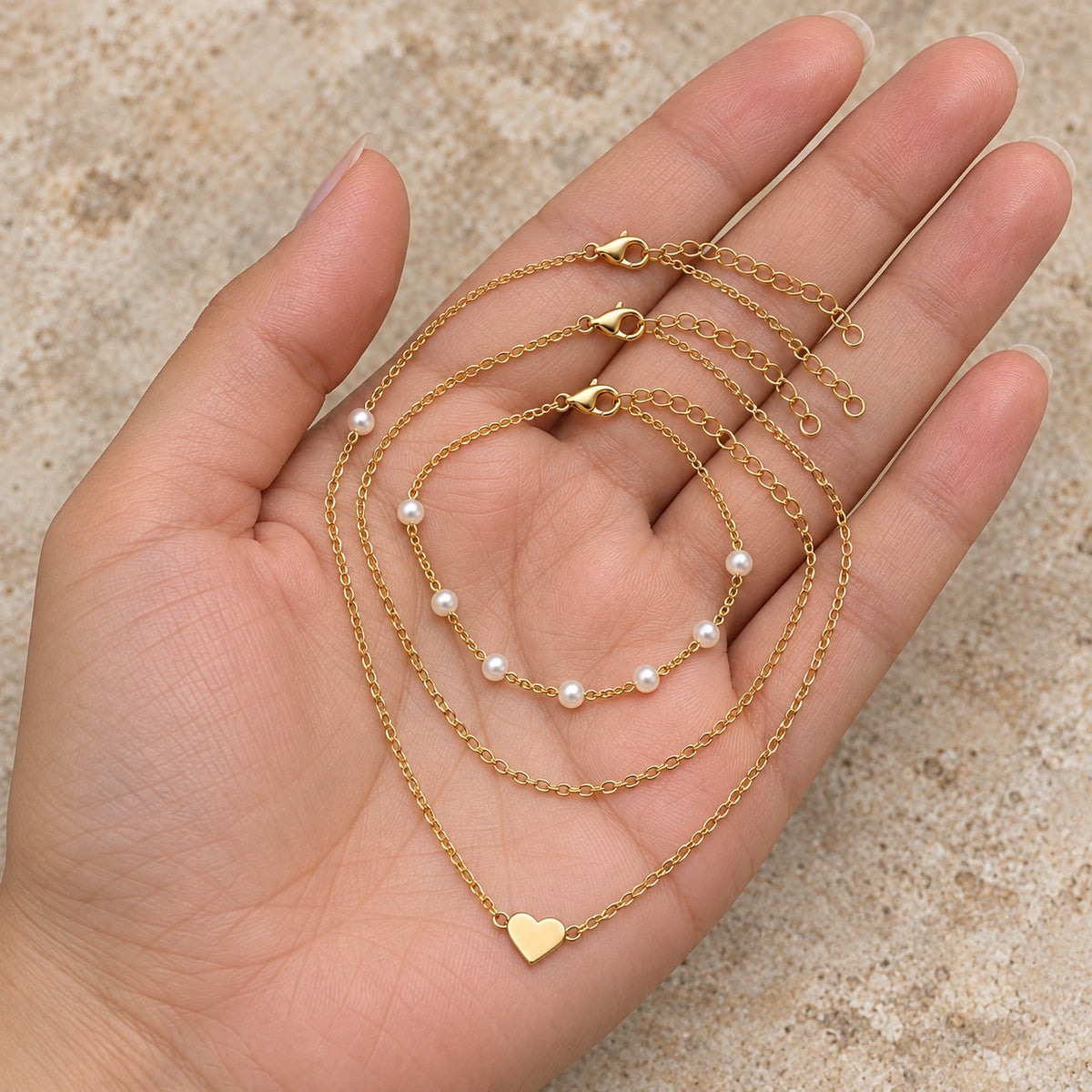 Layered Faux Pearl Necklace Set held in hand, showing its true scale