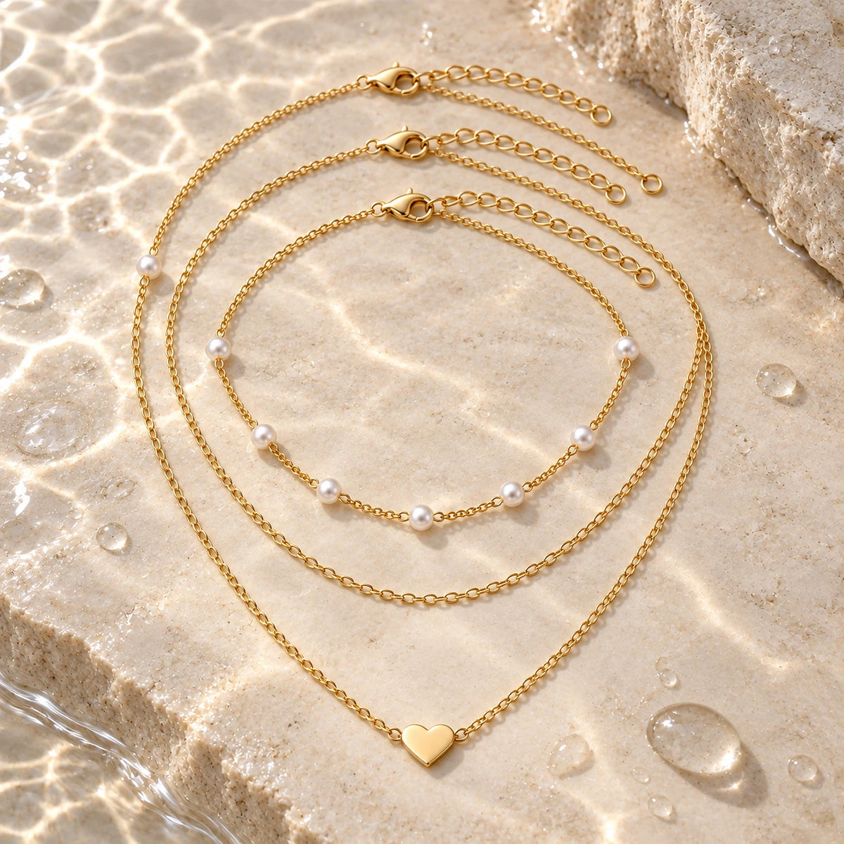Layered Faux Pearl Necklace Set with water droplets on stone