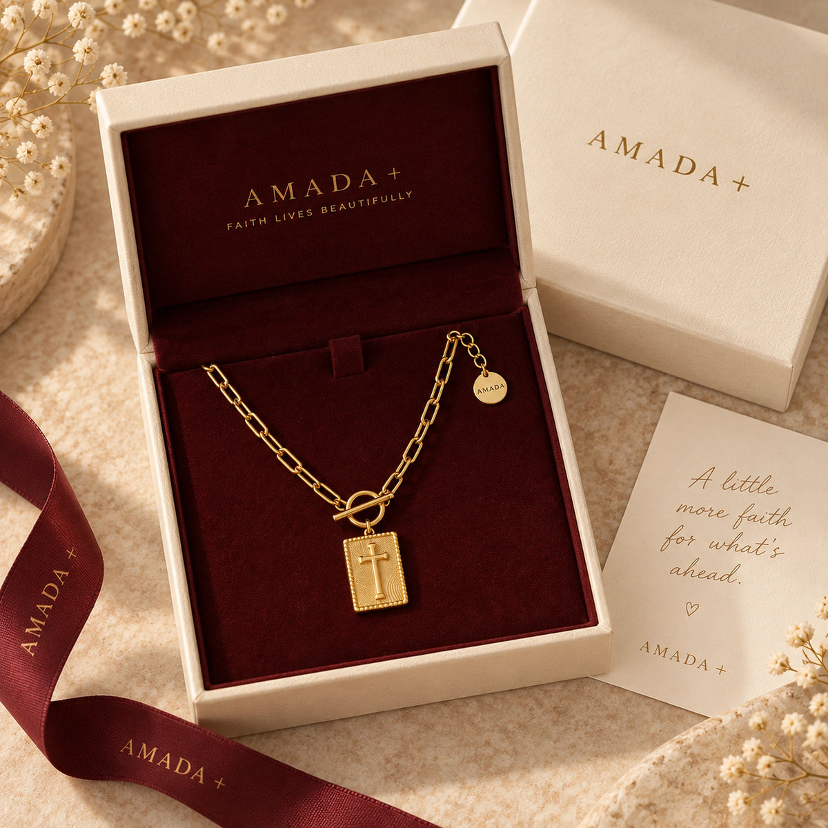 Amada Nail Cross Necklace displayed in an open Amada gift box with a card.