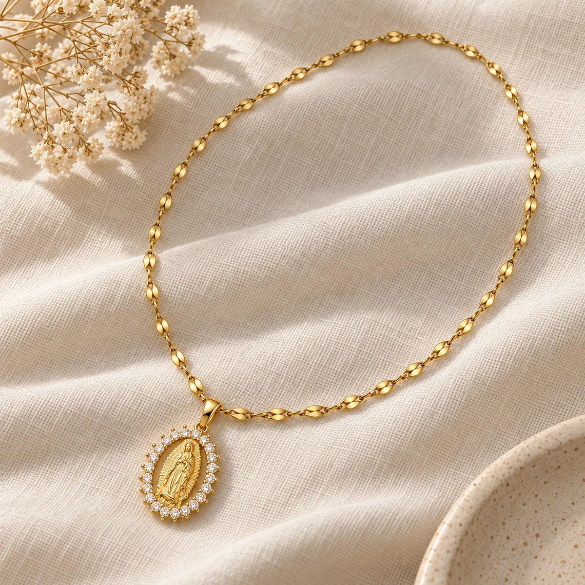 Our Lady of Guadalupe Necklace laid flat on linen