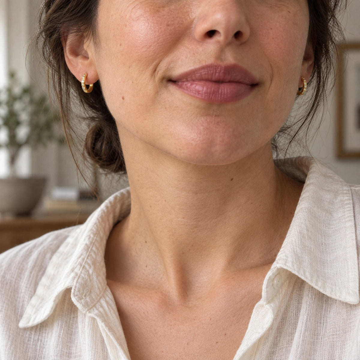 Amada Pave Huggie Earrings worn by a woman, shown from another angle.