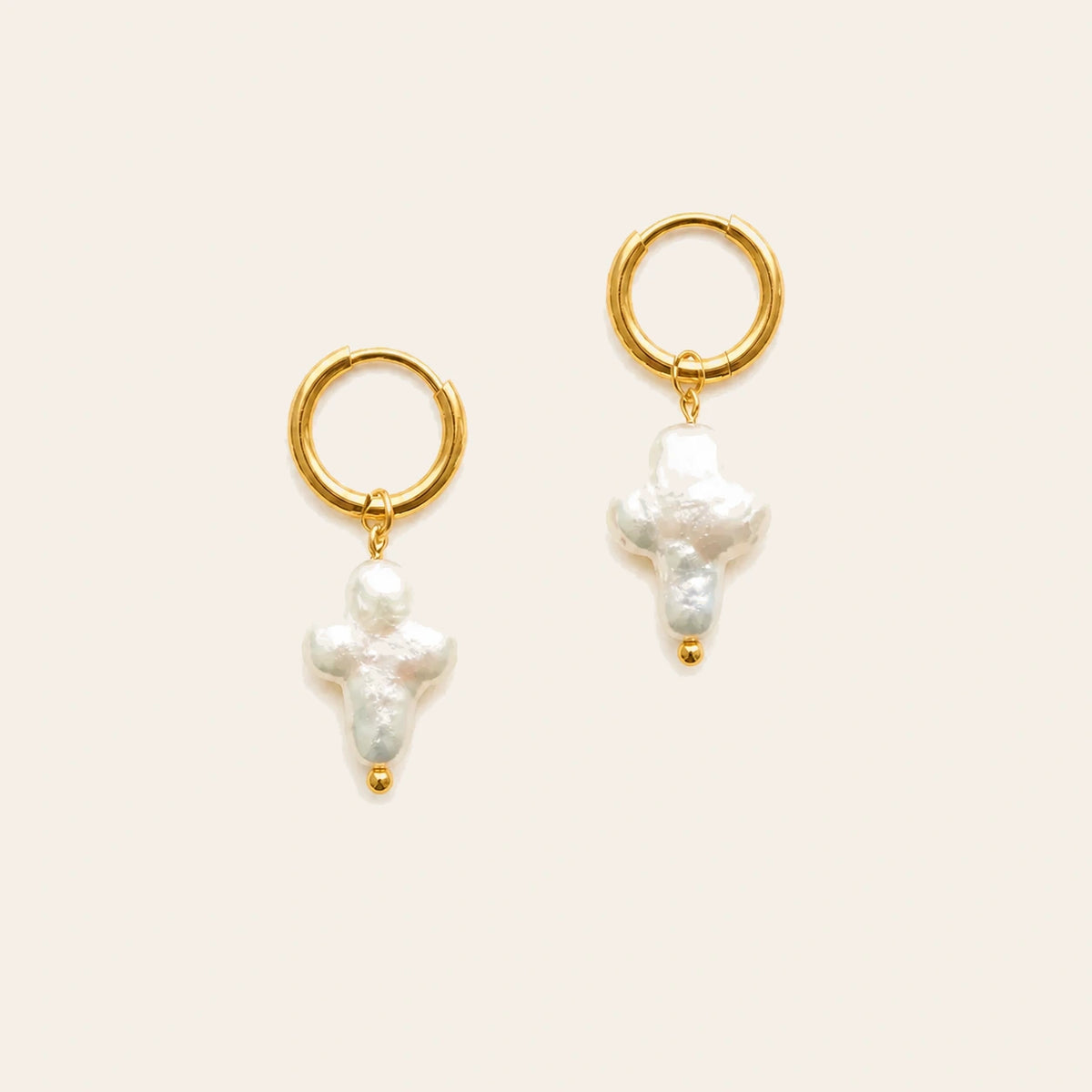 Amada Pearl Cross Earrings on ivory background