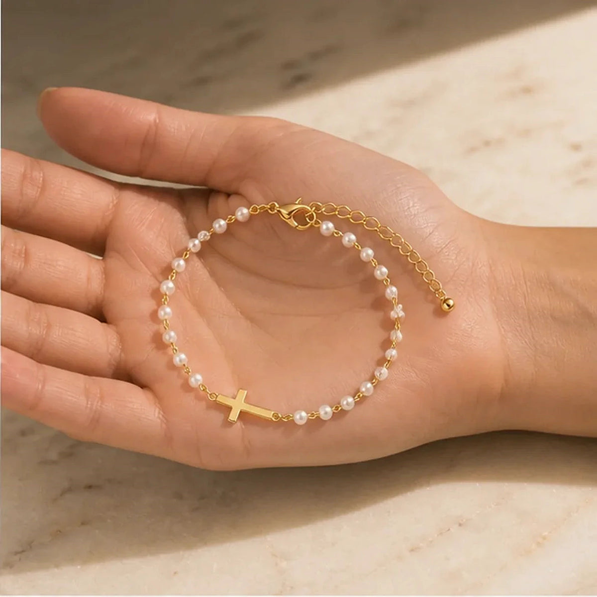 Amada | Pearl Cross of Grace Bracelet | scale in hand | cycle 3