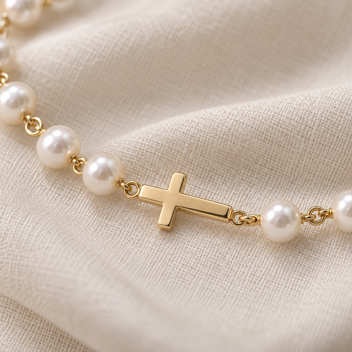 Close-up of the pearls, gold links and integrated cross.