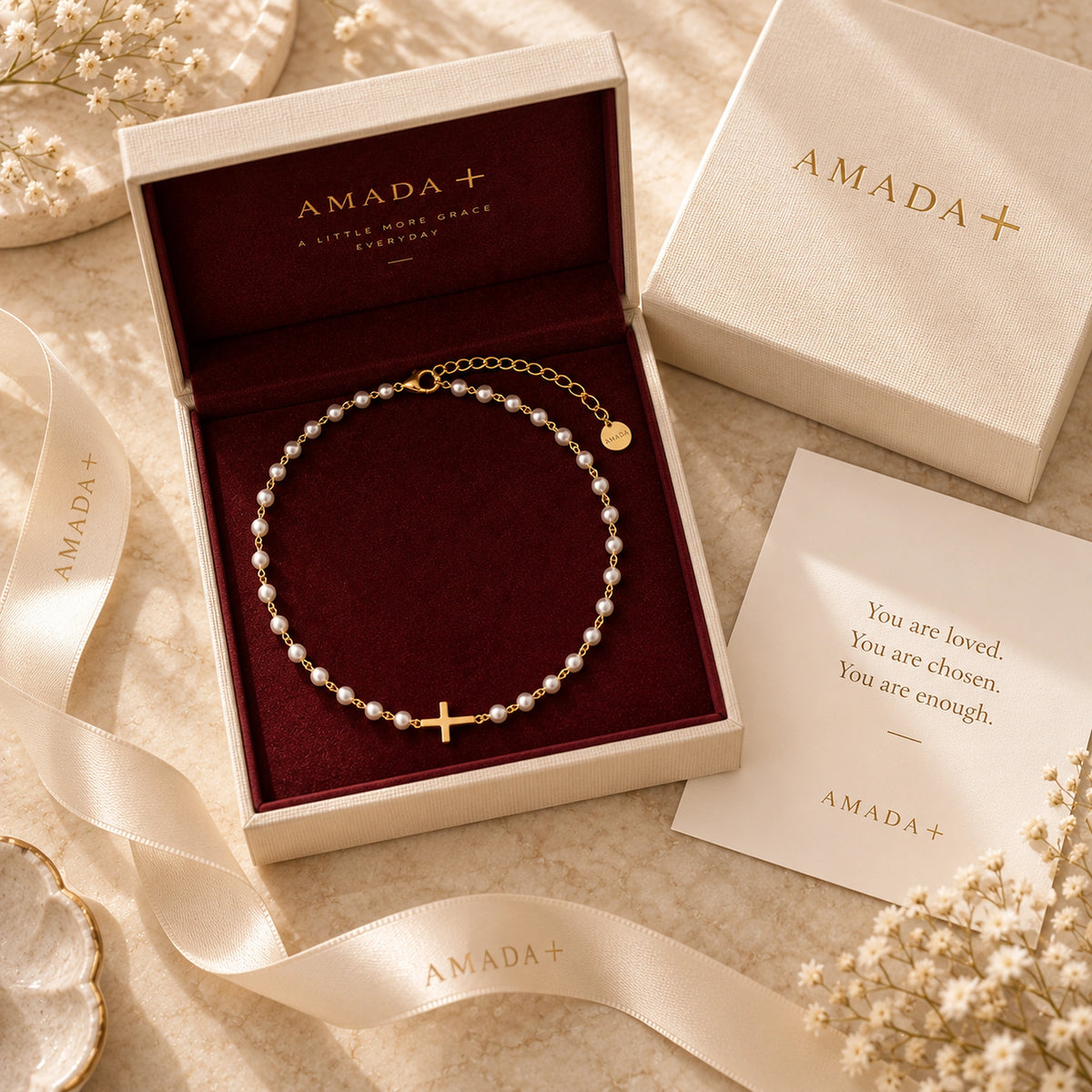 Pearl Cross of Grace Necklace arranged in an Amada gift box with a card and ribbon.