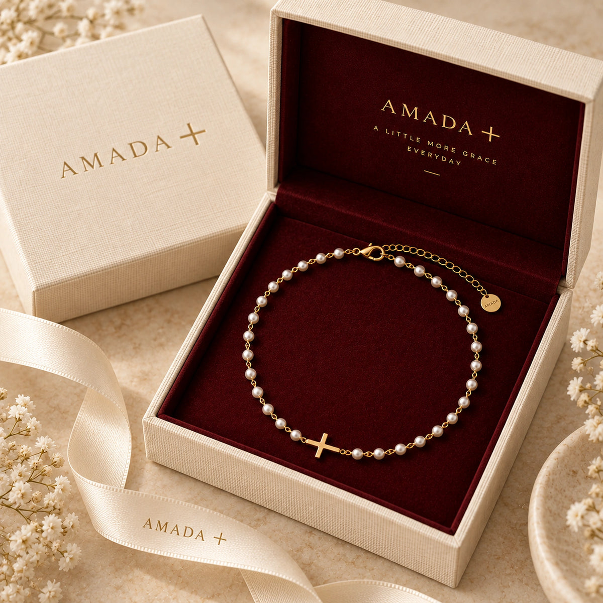 Pearl Cross of Grace Necklace inside an open Amada gift box.