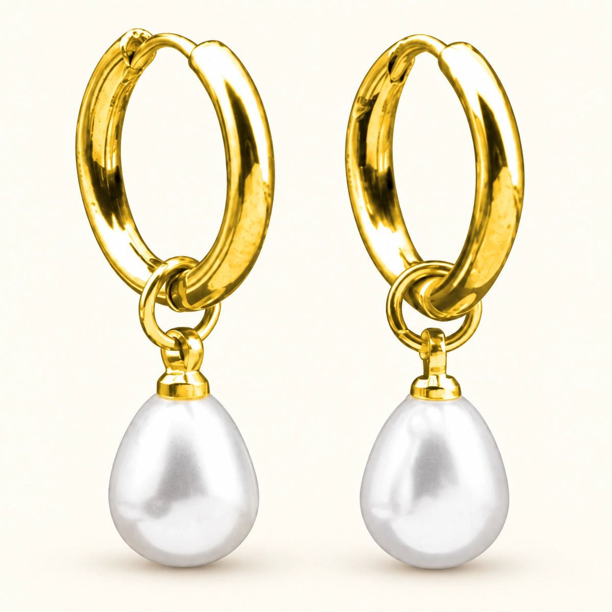Amada Petite Faux Pearl Huggie Earrings on a plain light background.