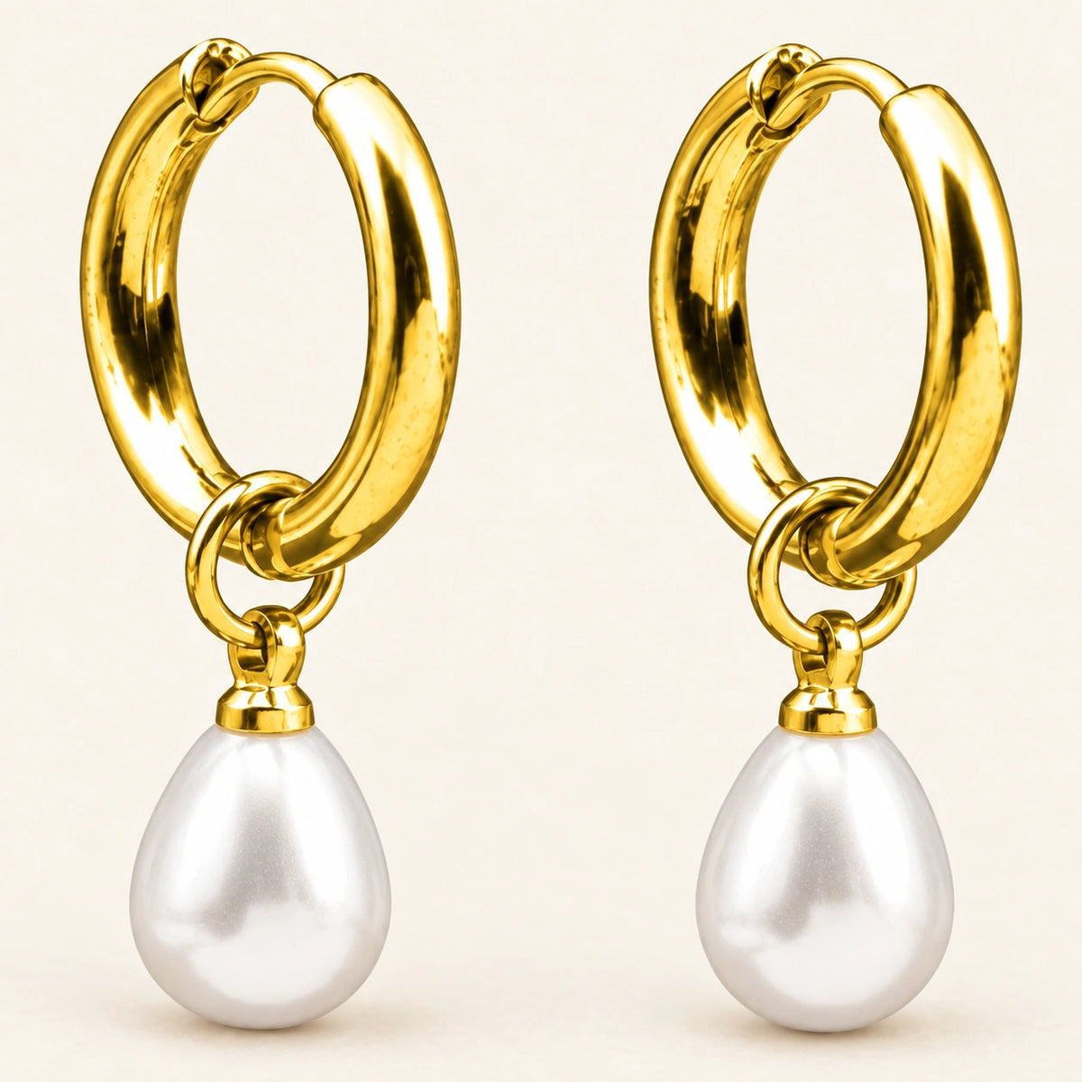 Close-up of the Amada Petite Faux Pearl Huggie Earrings showing its detail and finish.