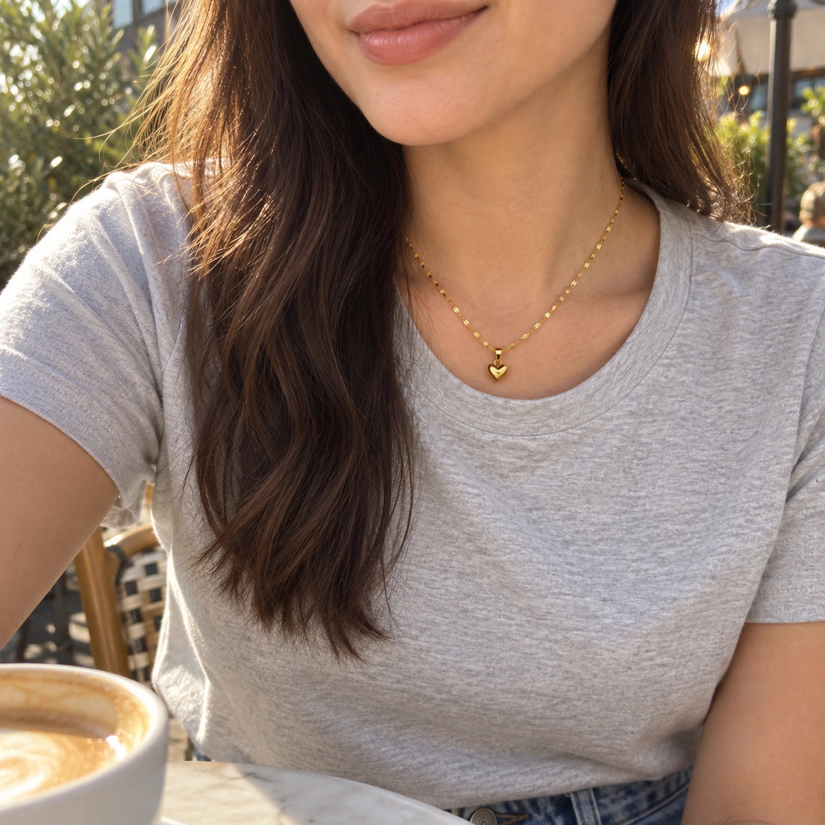 Amada Puffy Heart Necklace worn by a woman, shown from another angle.