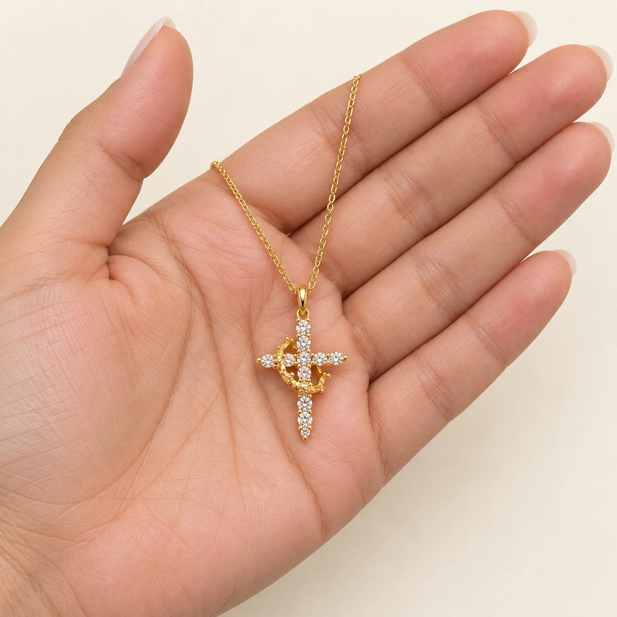 Rotating Crown Cross Necklace shown for scale
