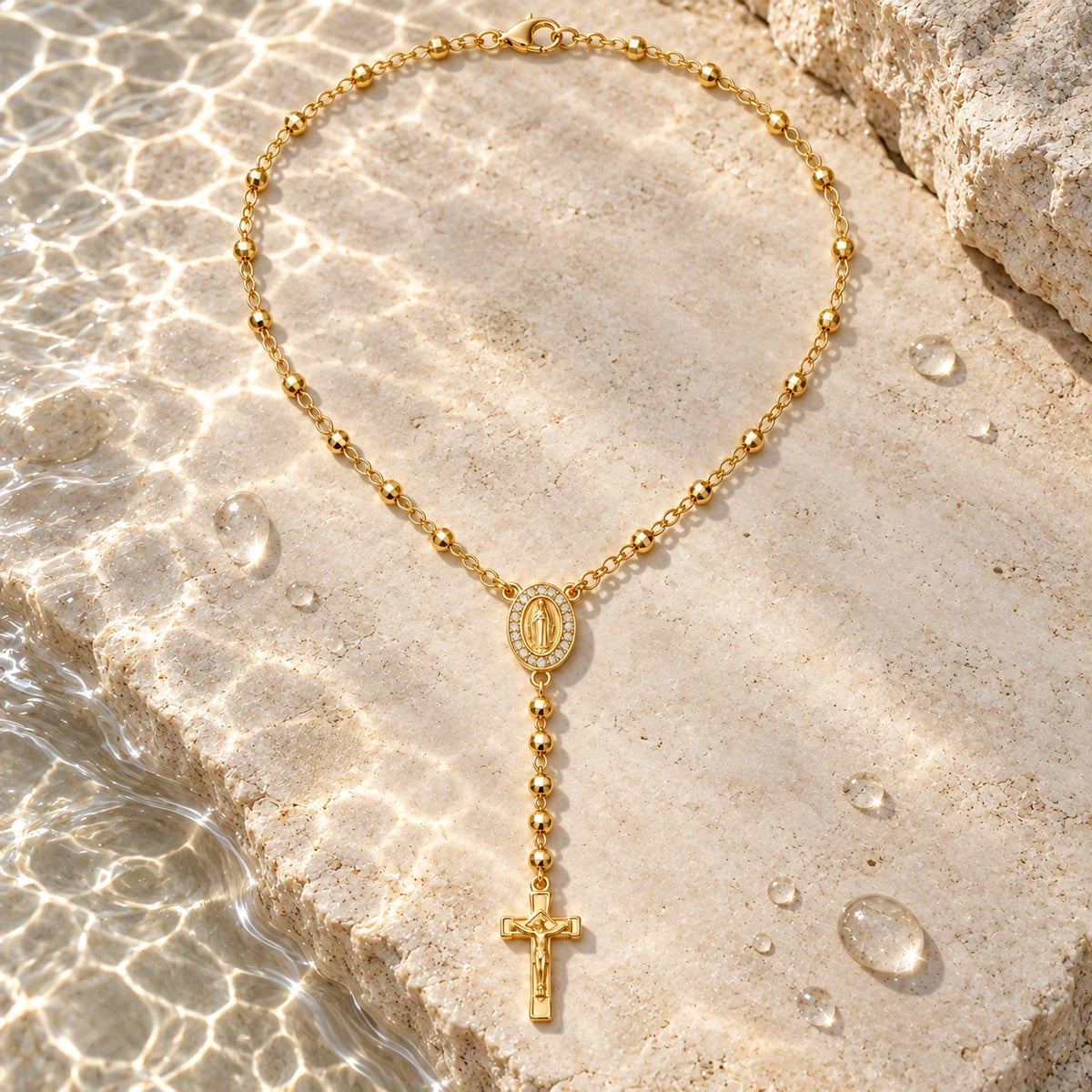 Sacred Rosary Necklace with water droplets on stone