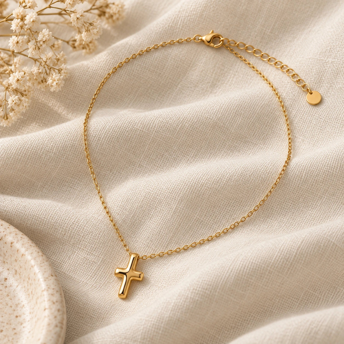 The Bold Cross Necklace laid flat on linen