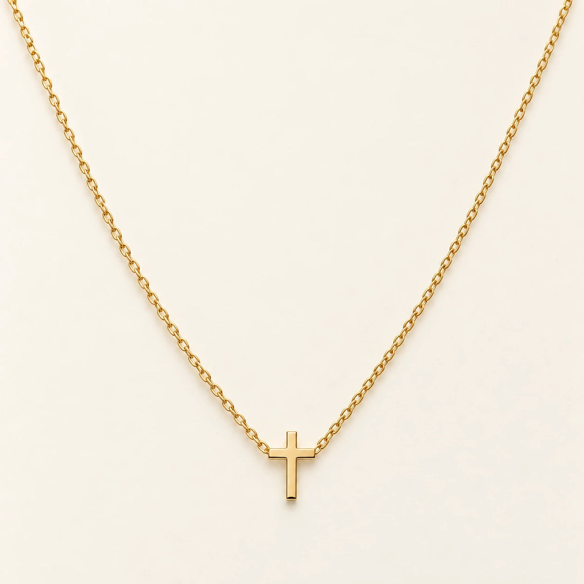 The Classic Cross Necklace, gold-plated stainless steel, shown on its own