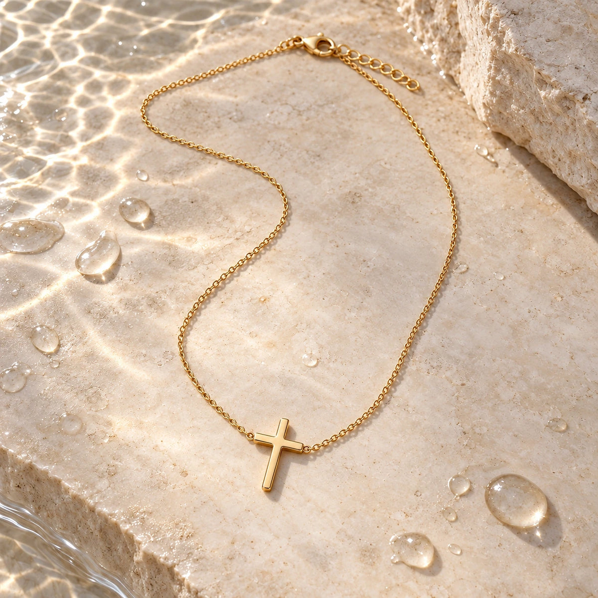 The Classic Cross Necklace with water droplets on stone