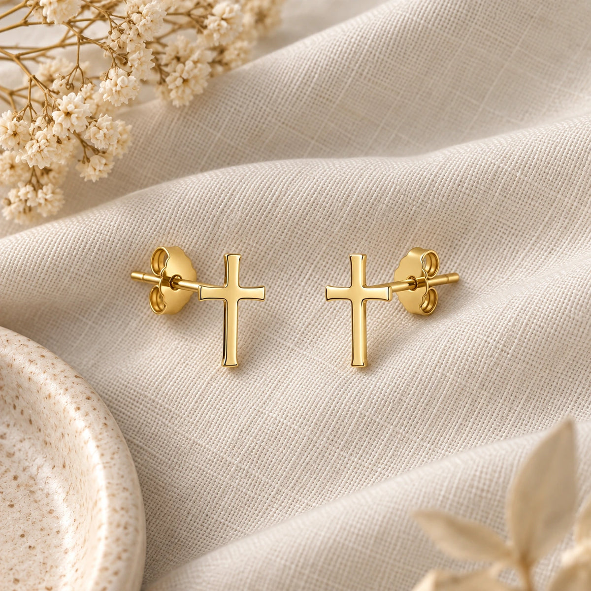 The Cross Studs laid flat on linen