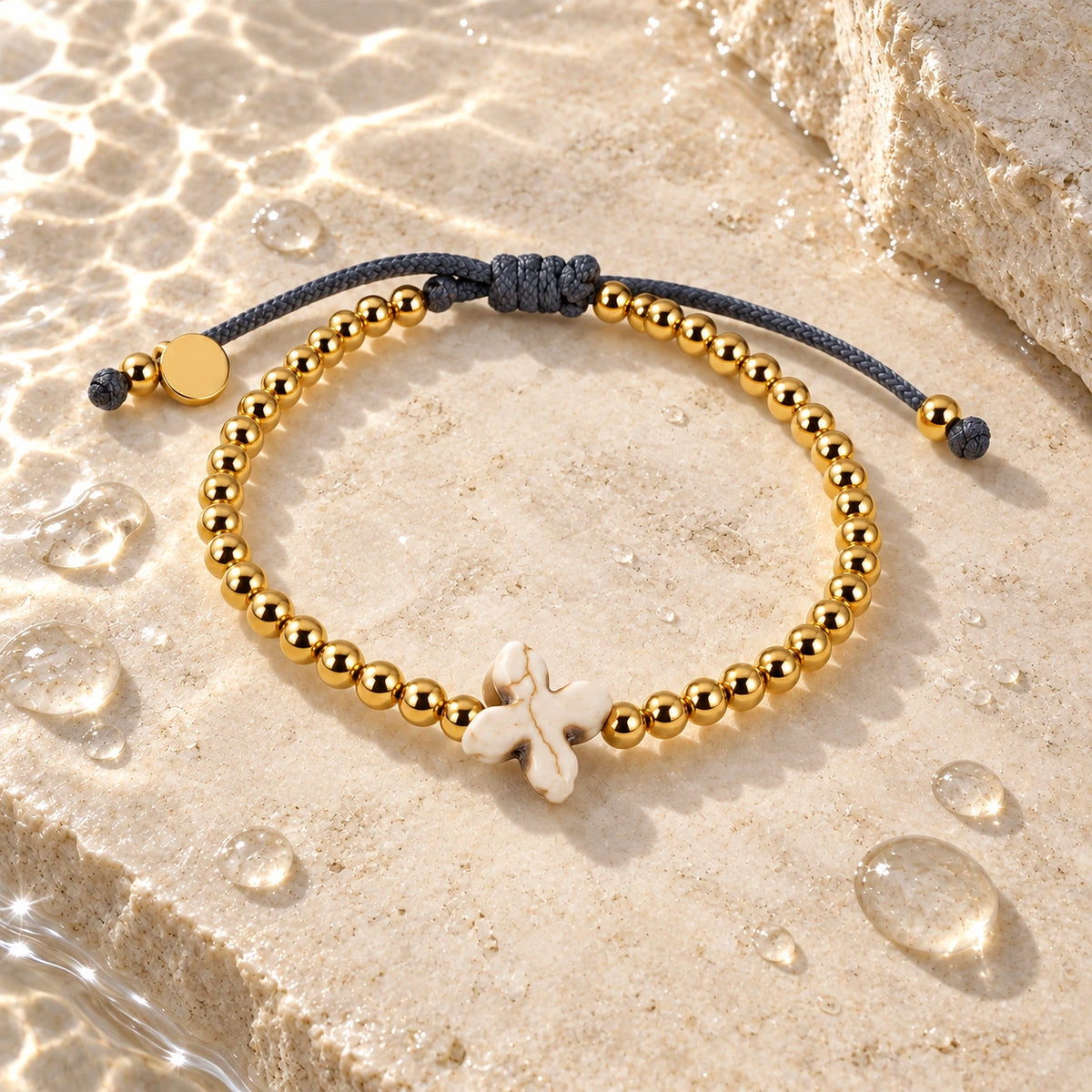 The Prayer Bracelet with water droplets on stone