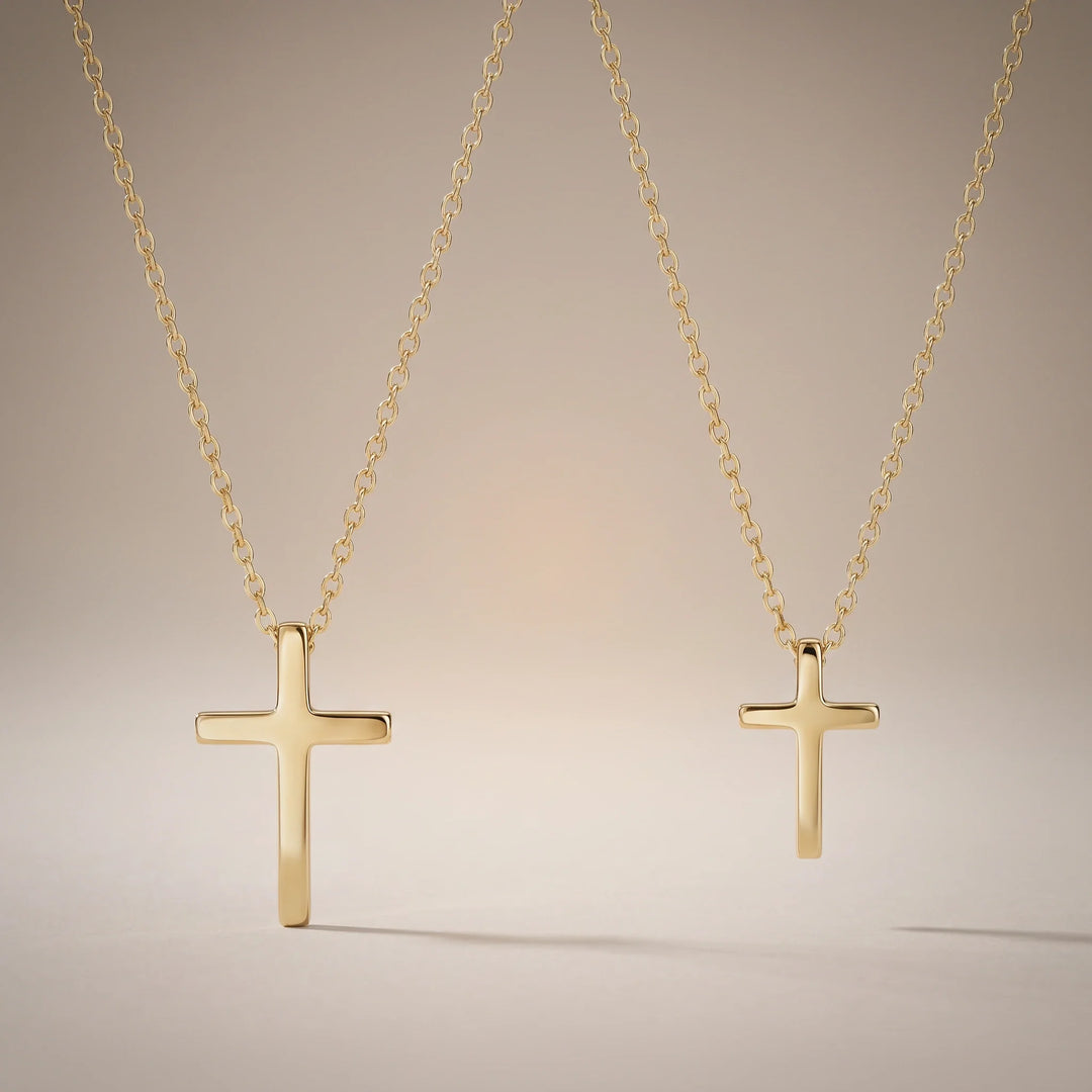 Godmother & Me, two matching sealed 18K gold cross necklaces, on a plain background