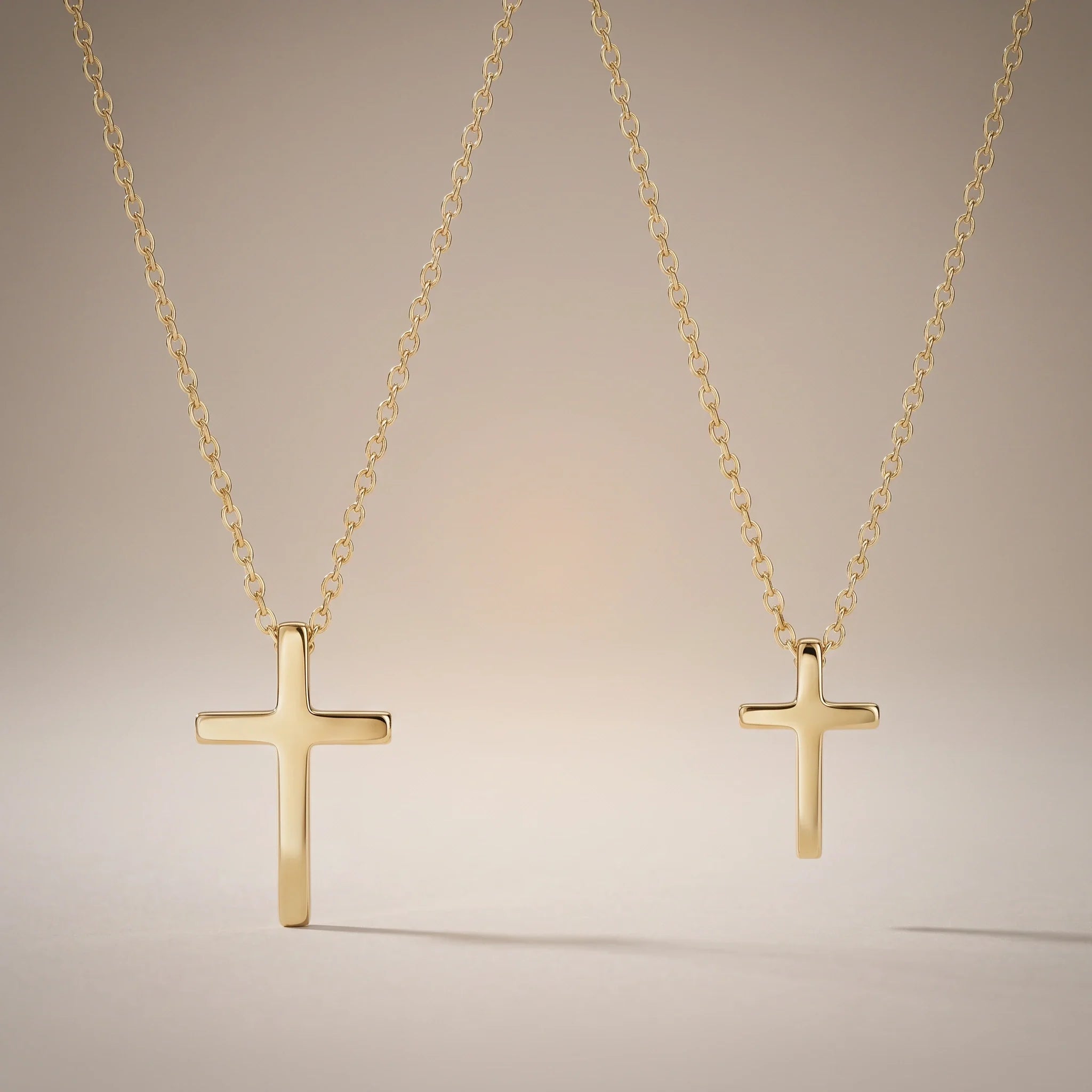 Godmother & Me, two matching sealed 18K gold cross necklaces, on a plain background